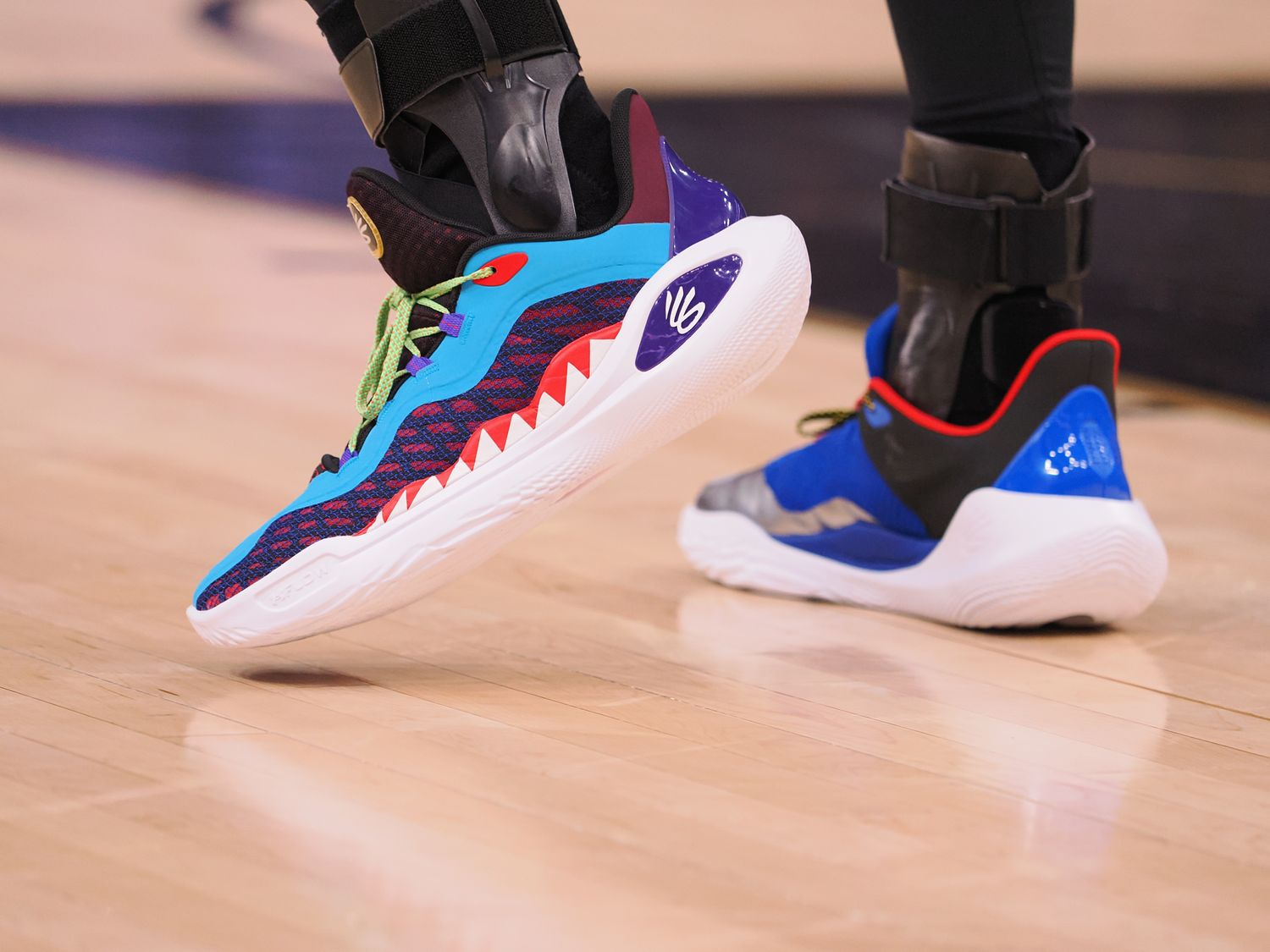 Golden State Warriors guard Stephen Curry's multicolor Under Armour sneakers.